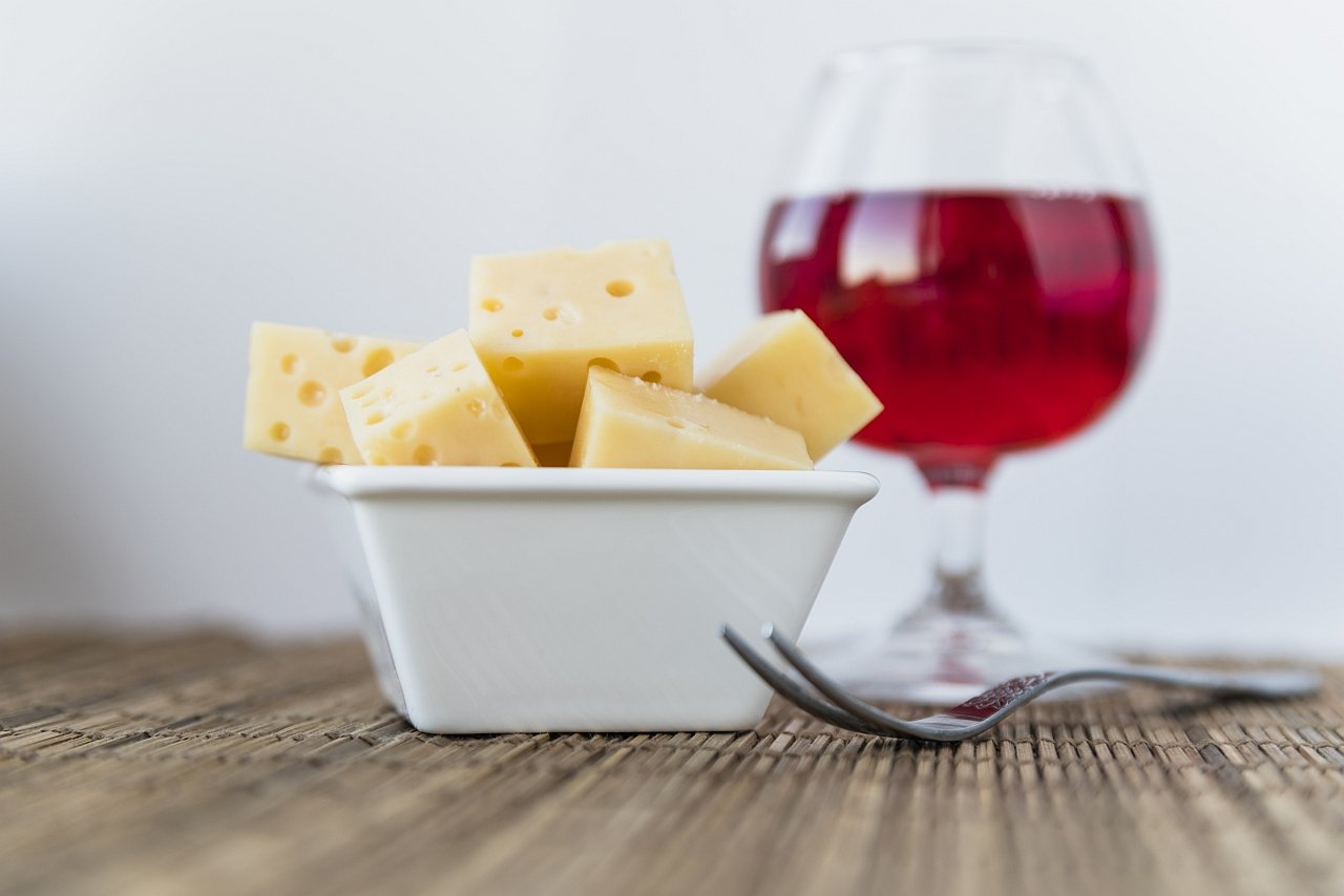 set-fresh-cheese-saucer-near-glass-drink